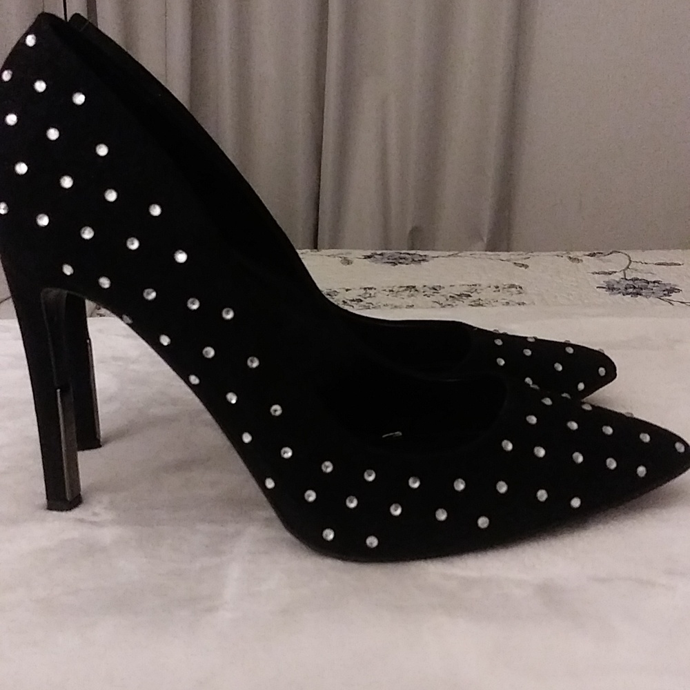 This is a DKNY pair of shoe, size 11, black in color with shiny glossy beads.